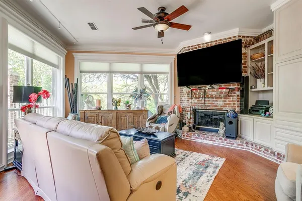 a living room with fireplace furniture and a flat screen tv