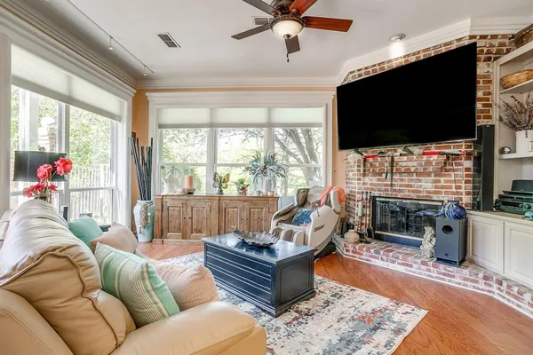 a living room with fireplace furniture and a flat screen tv