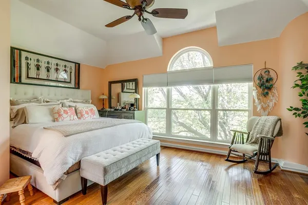 a bedroom with a bed and a large window