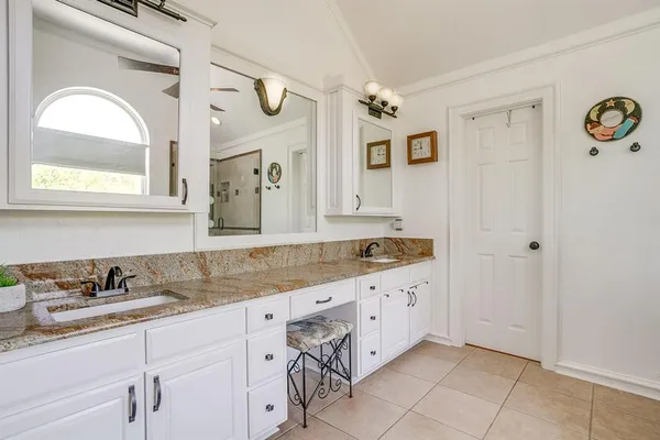 a bathroom with a granite countertop sink mirror and vanity