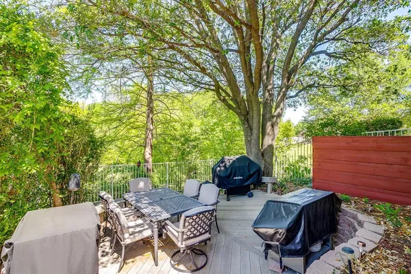 a view of backyard of house with seating area