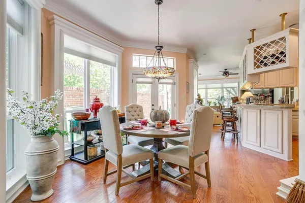 a dining room with furniture window and wooden floor