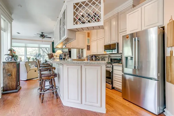 a kitchen with stainless steel appliances a refrigerator stove microwave and cabinets
