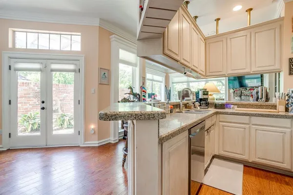 a kitchen with a sink cabinets and wooden floor