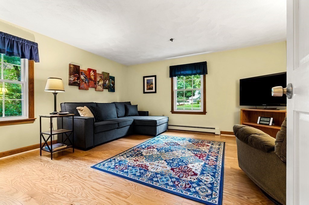 15 Fairview Farm Road Haverhill, MA 01832 - Photo 22 of 42 a living room with furniture and a flat screen tv