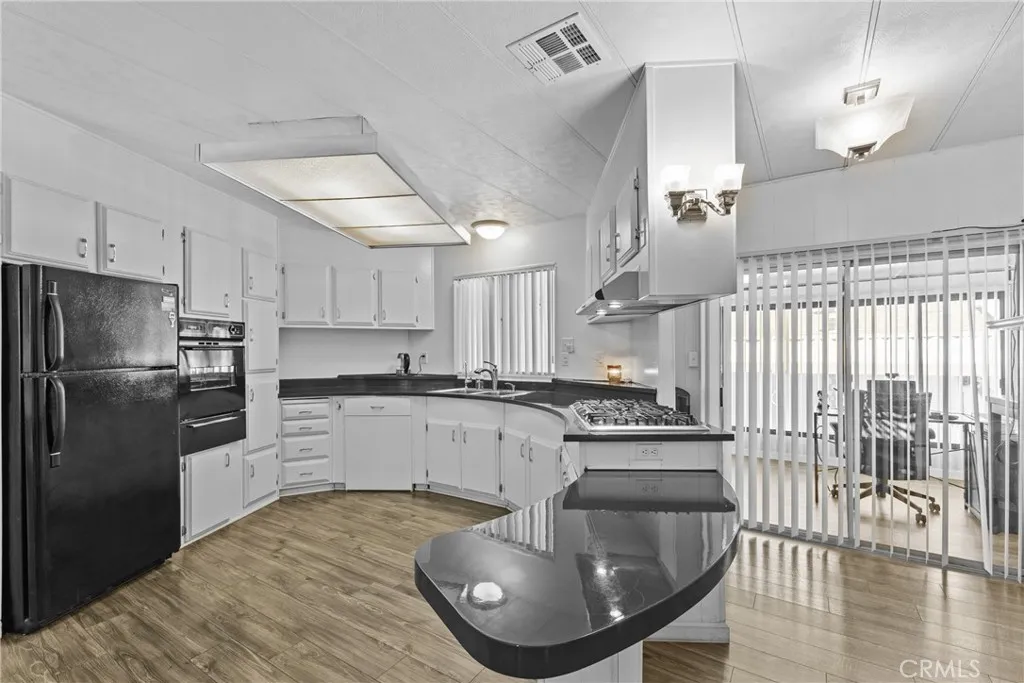 4000 Pierce Street, Unit 132 Riverside, CA 92505 - Photo 15 of 43 a kitchen with stainless steel appliances granite countertop a sink a stove and refrigerator