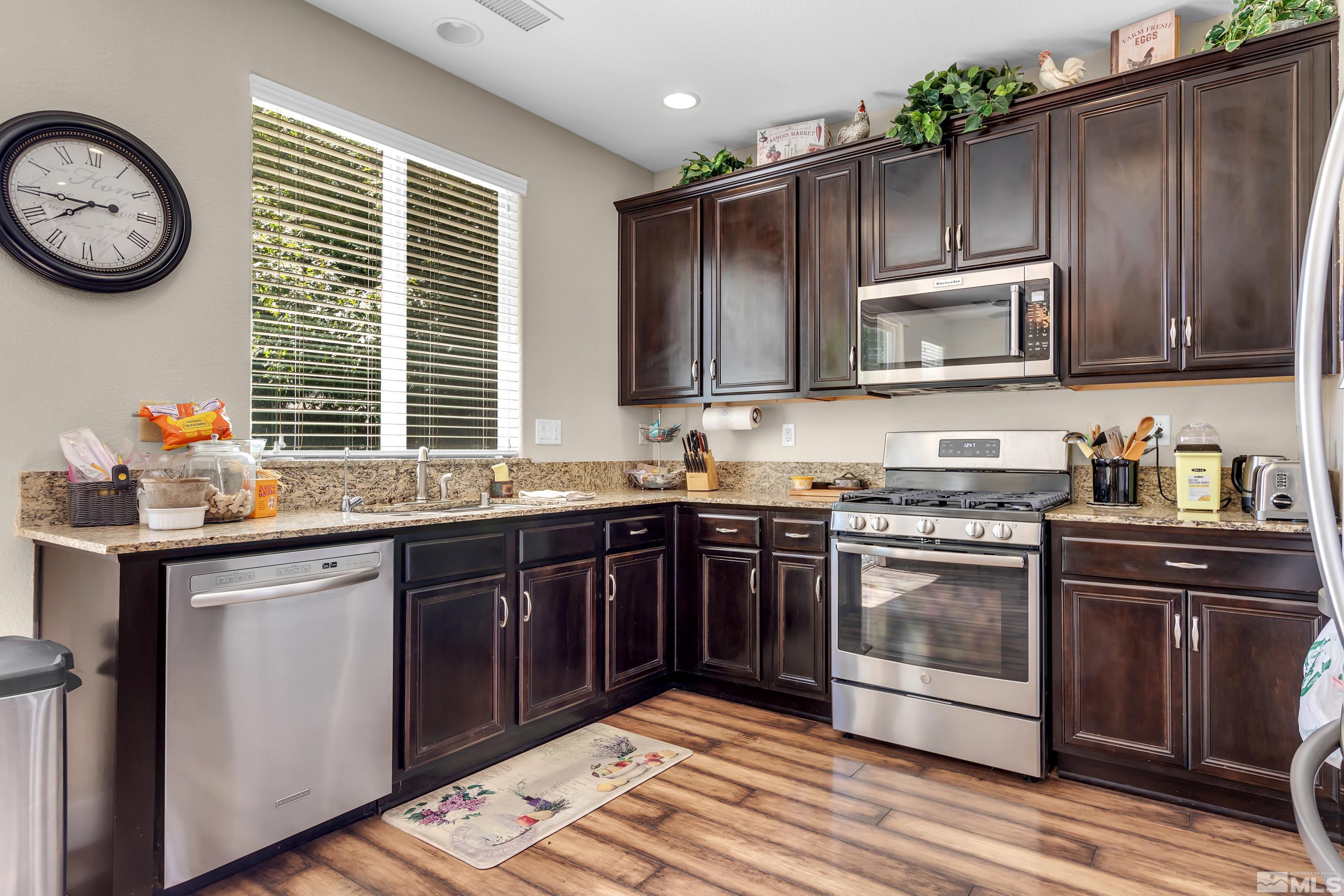 420 Manciano Way Reno, NV 89521 - Photo 14 of 30 a kitchen with a sink cabinets and stainless steel appliances
