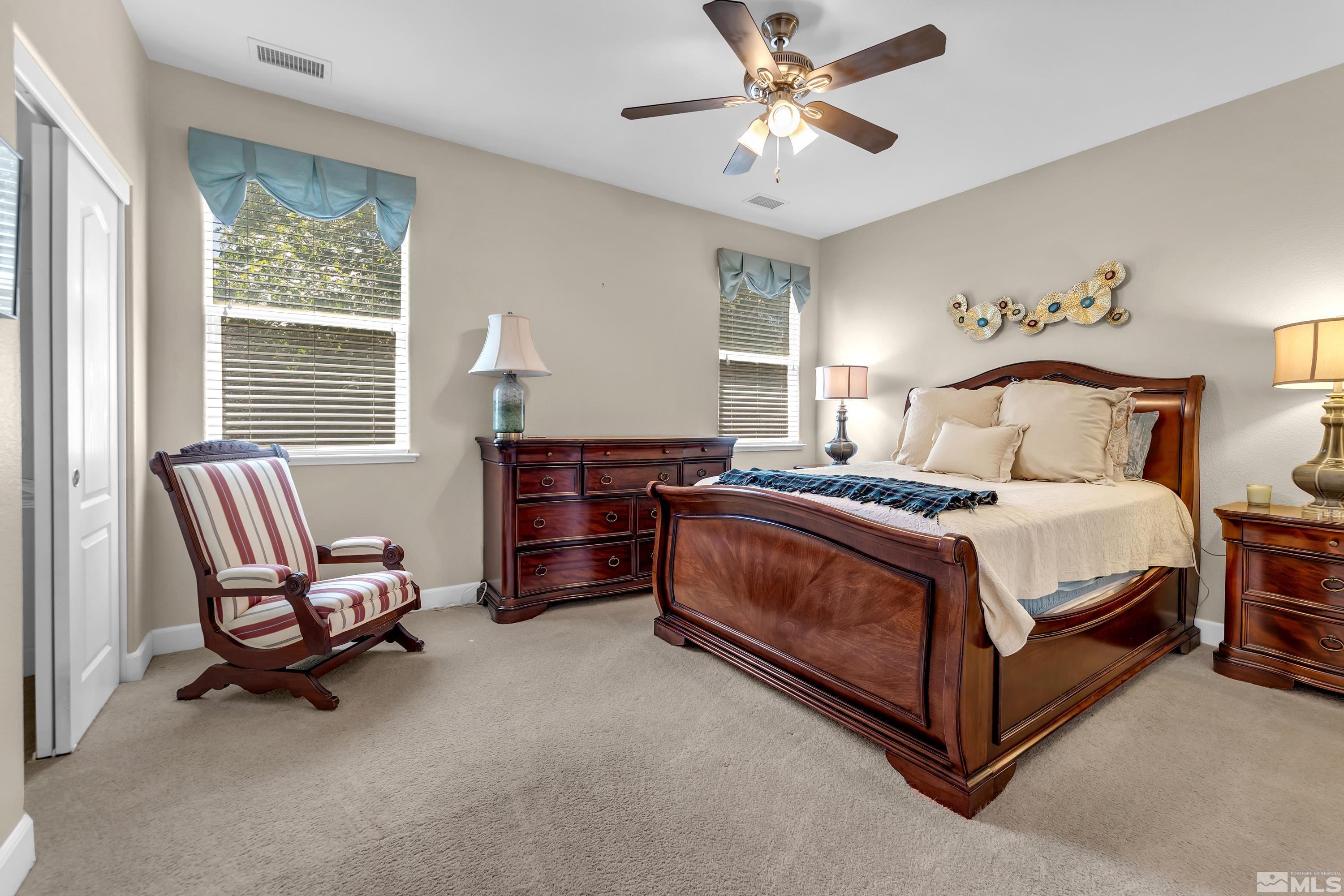 420 Manciano Way Reno, NV 89521 - Photo 15 of 30 a bedroom with a bed and a chandelier