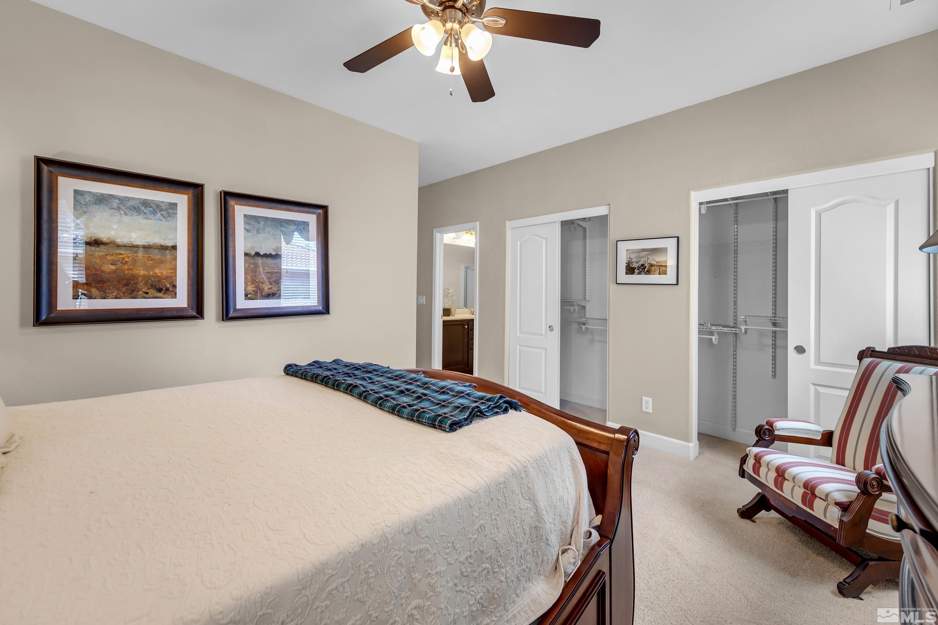 420 Manciano Way Reno, NV 89521 - Photo 18 of 30 a bedroom with a bed and a chandelier