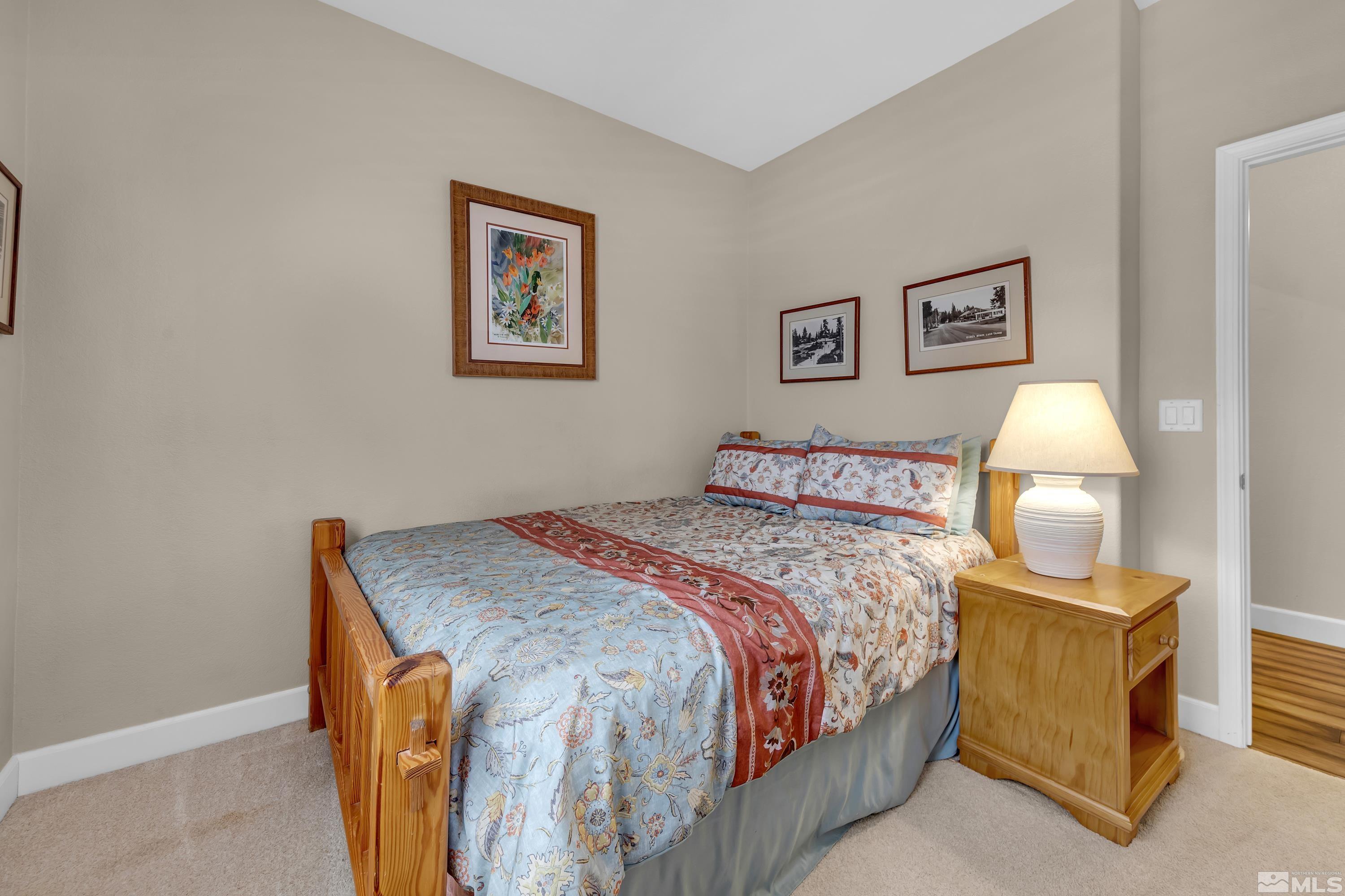 420 Manciano Way Reno, NV 89521 - Photo 19 of 30 a bedroom with a bed and a lamp on table