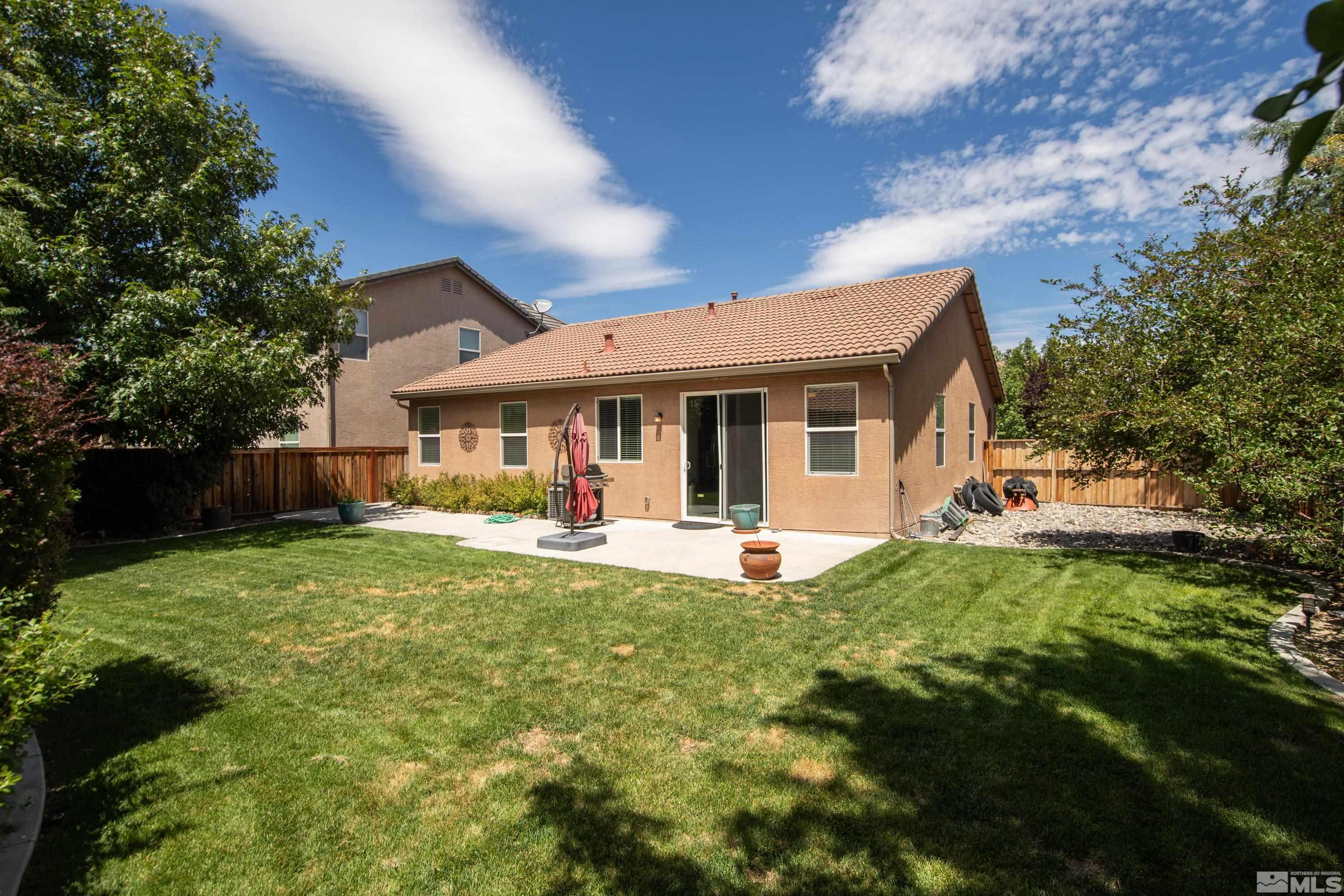 420 Manciano Way Reno, NV 89521 - Photo 26 of 30 a front view of a house with a garden and porch