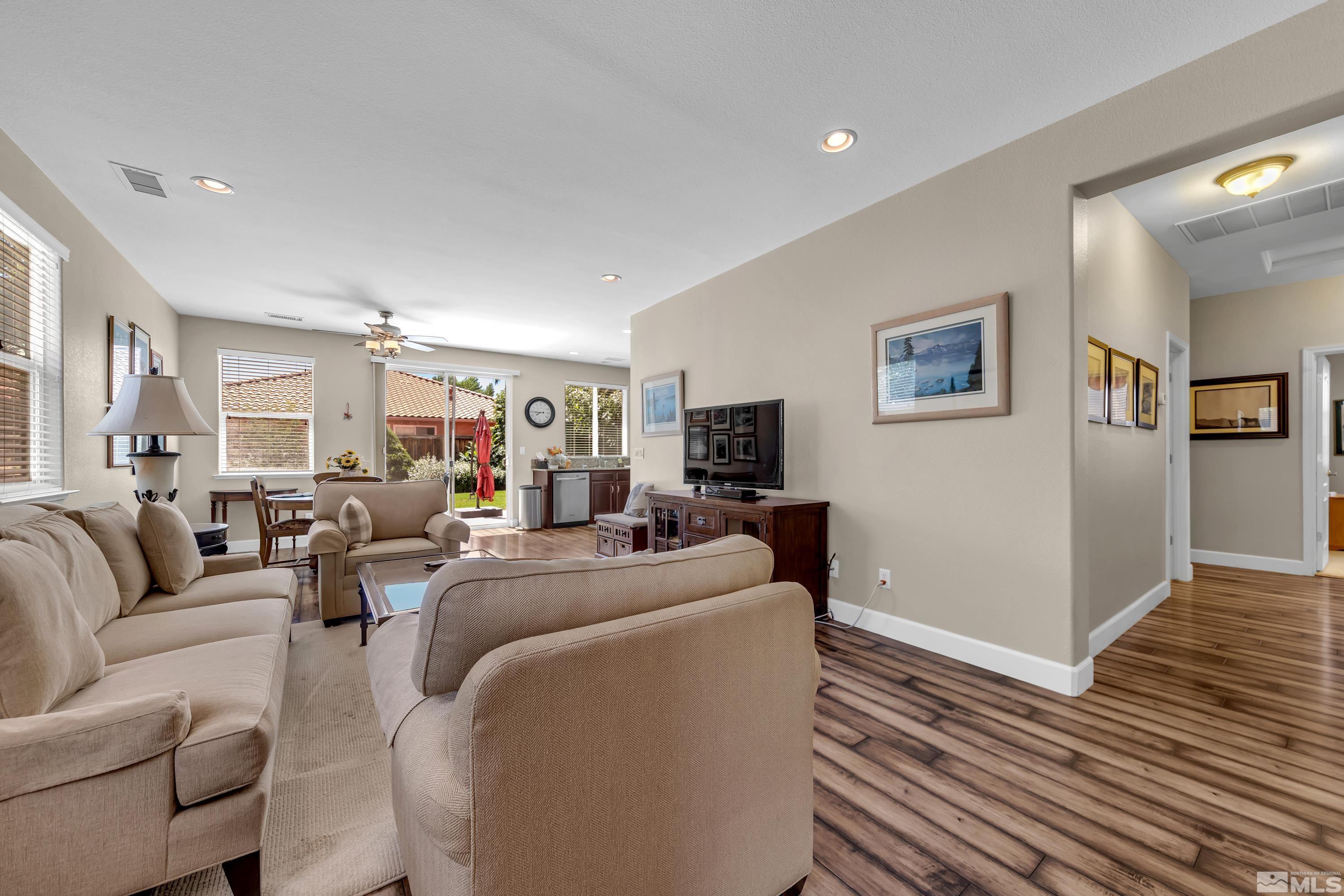 420 Manciano Way Reno, NV 89521 - Photo 3 of 30 a living room with furniture a flat screen tv and a wooden floor