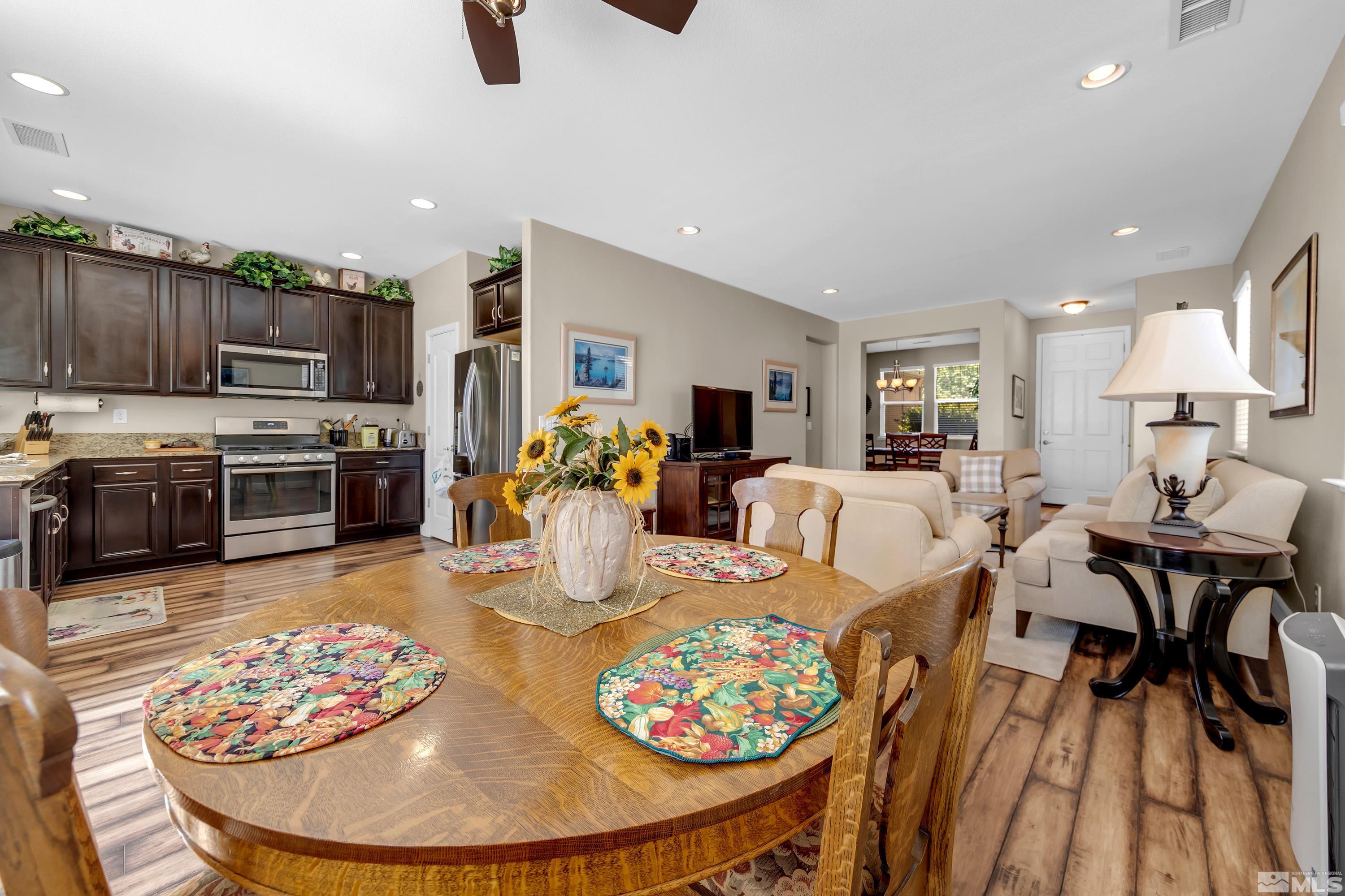 420 Manciano Way Reno, NV 89521 - Photo 4 of 30 a view of a dining room with furniture a kitchen and chandelier