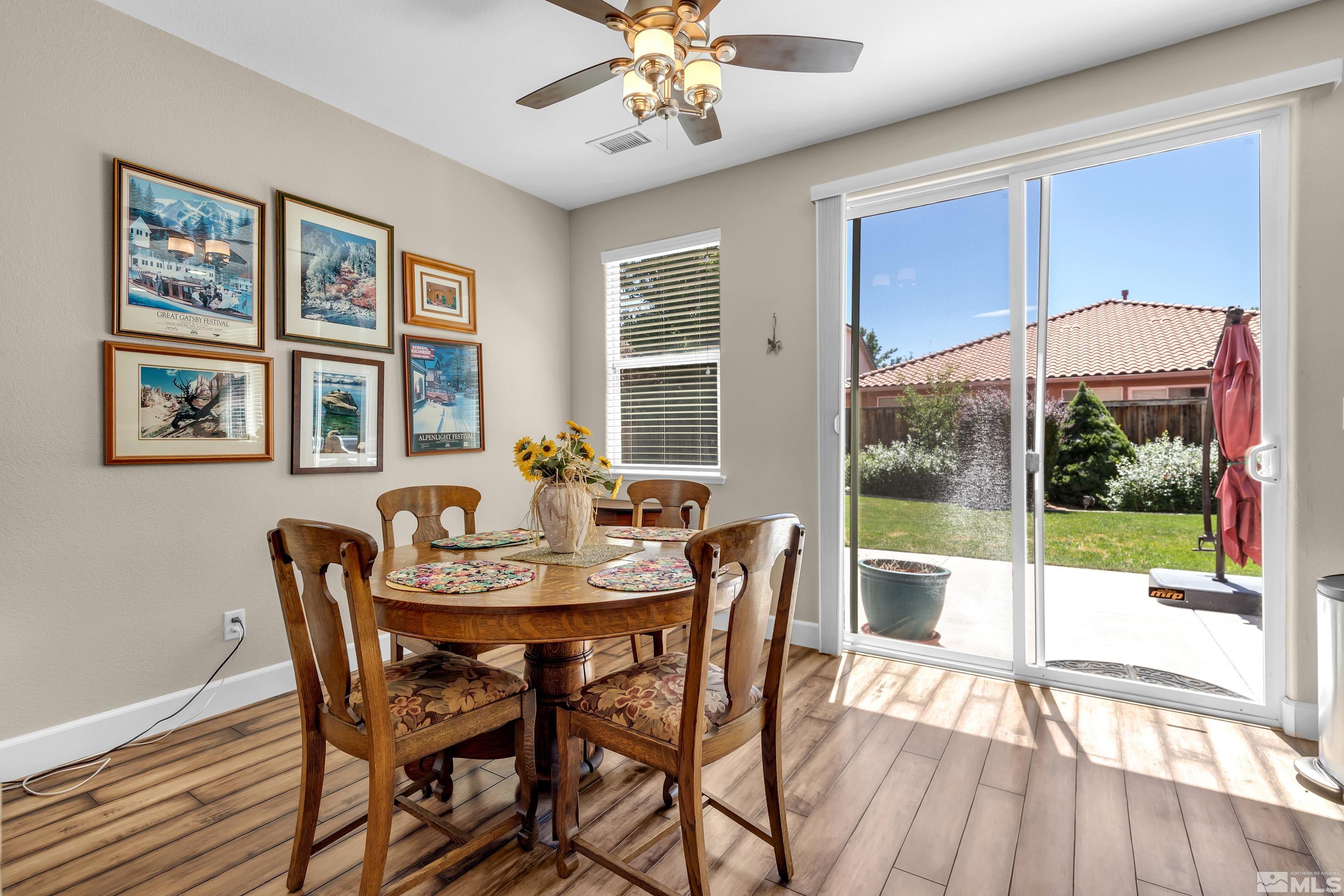 420 Manciano Way Reno, NV 89521 - Photo 5 of 30 a dining room with furniture a chandelier and wooden floor