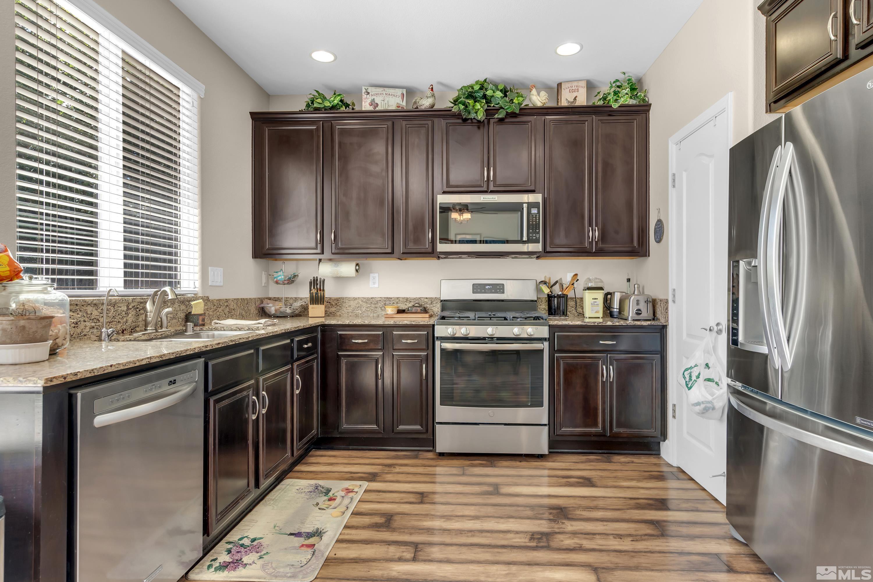 420 Manciano Way Reno, NV 89521 - Photo 10 of 30 a kitchen with a sink stove and refrigerator