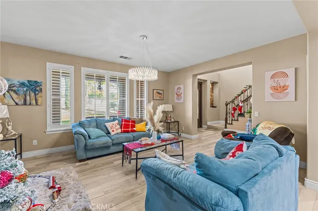 a kitchen with stainless steel appliances granite countertop a refrigerator a stove and a wooden floors