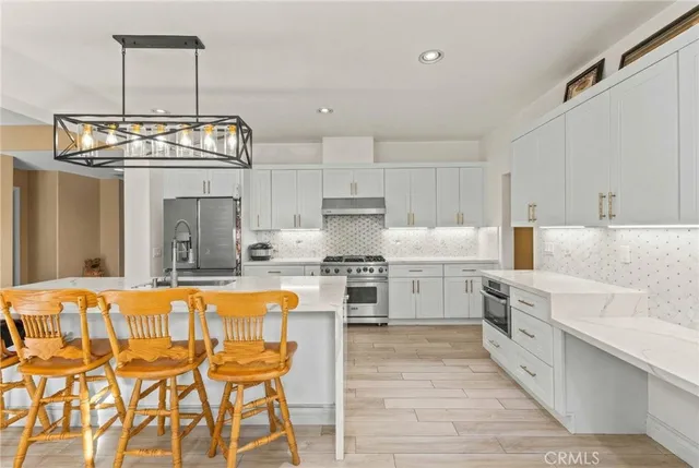 a living room with furniture a chandelier and a window