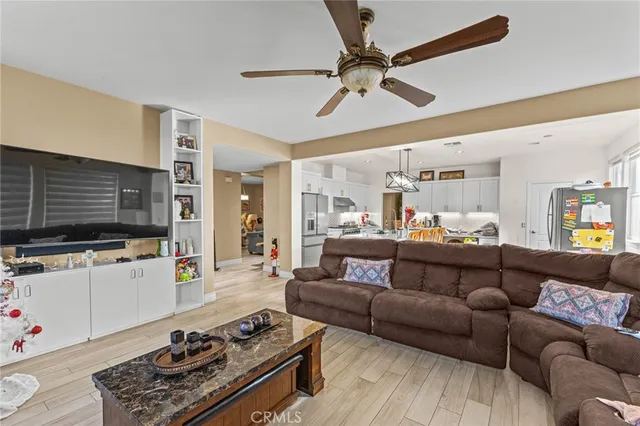a view of a livingroom with furniture wooden floor and windows