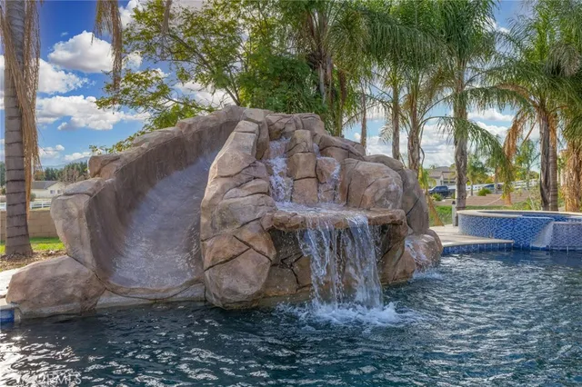 a view of a dry yard with wooden fence