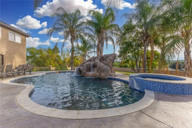 a vase of flowers sitting on a floor next to a blue wall