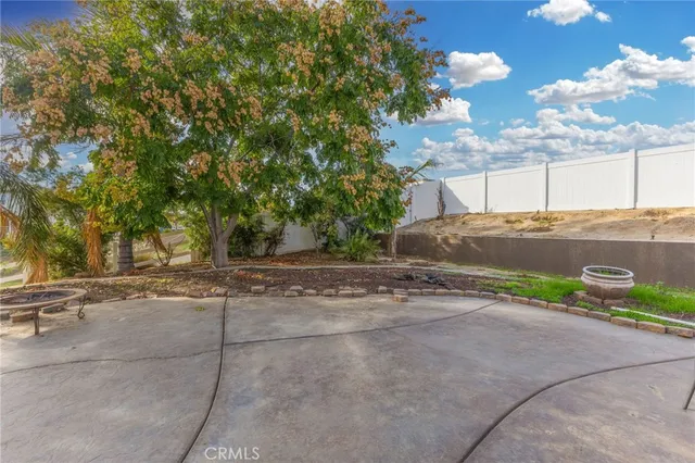 a vase of flowers sitting on a floor next to a blue wall