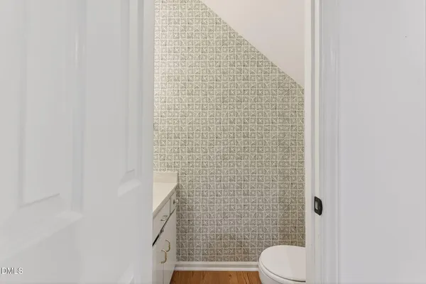a bathroom with a toilet and a shower curtain