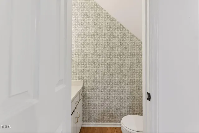 a bathroom with a toilet and a shower curtain