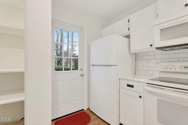 a white refrigerator freezer sitting inside of a kitchen