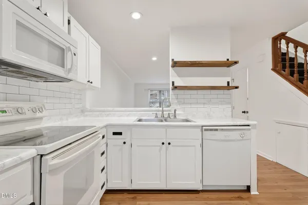 a kitchen with a sink cabinets and a window