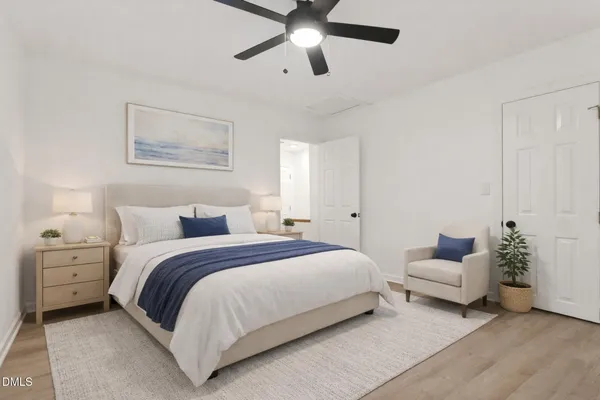 a spacious bedroom with a bed and ceiling fan