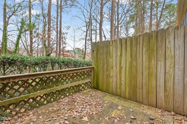 a view of a wooden fence with a large tree