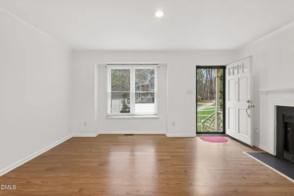 wooden floor in an empty room with a window