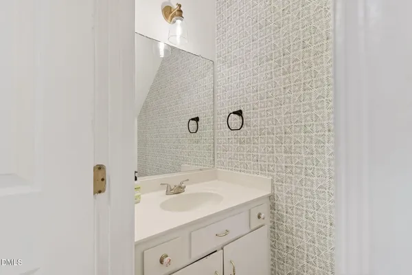 a bathroom with a sink a mirror and shower