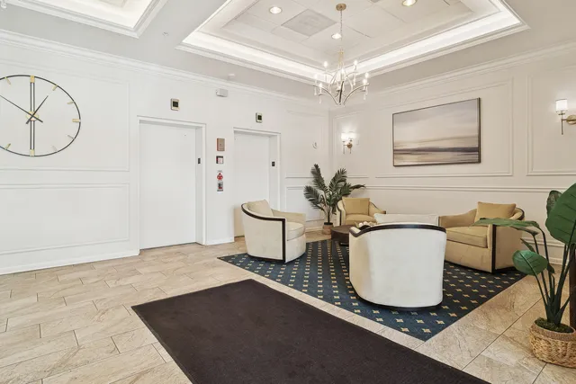 a living room with a couch and chandelier