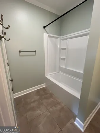 a bathroom with a bathtub and shower