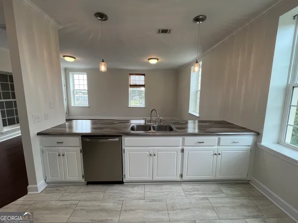 a kitchen with a sink and cabinets