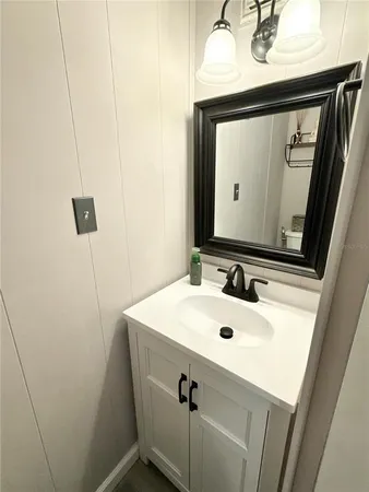 a bathroom with a sink a mirror and vanity