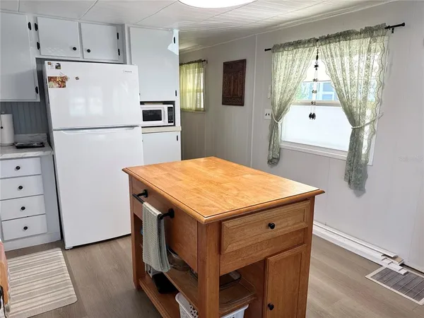 a kitchen with a refrigerator and countertop