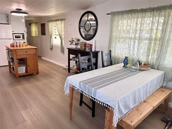 a bedroom with a bed a mirror and a table in it