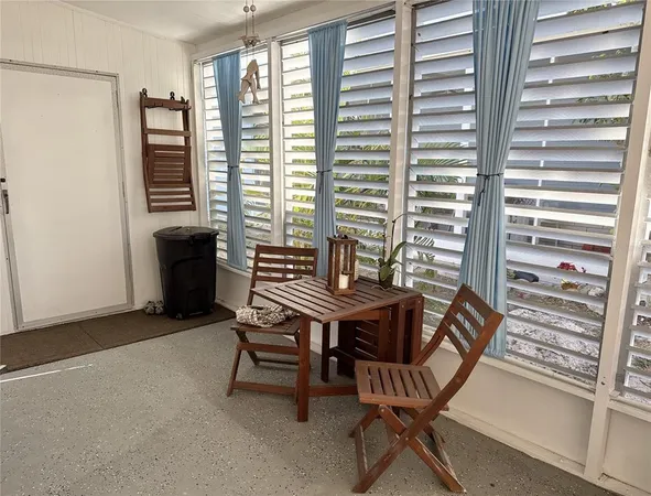 a dining room with furniture and windows