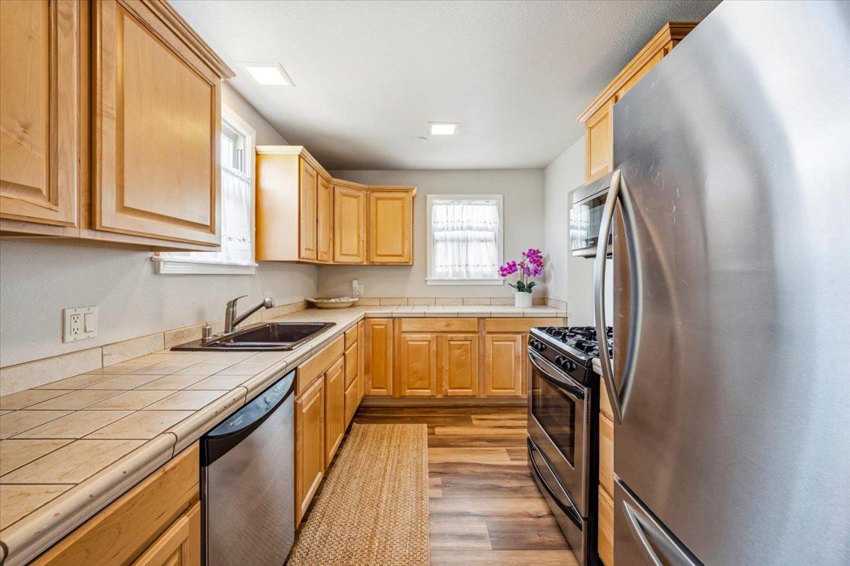 232 Upper Slate Creek Road Grass Valley, CA 95945 - Photo 10 of 48 a kitchen with stainless steel appliances granite countertop a sink stove and refrigerator
