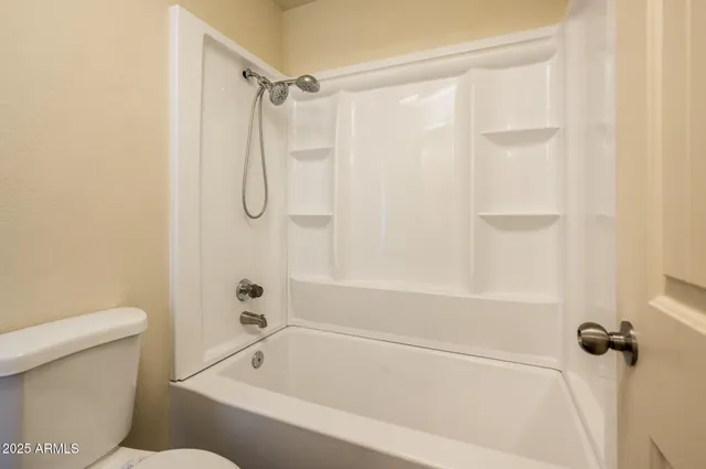 a bathroom with a shower and a toilet