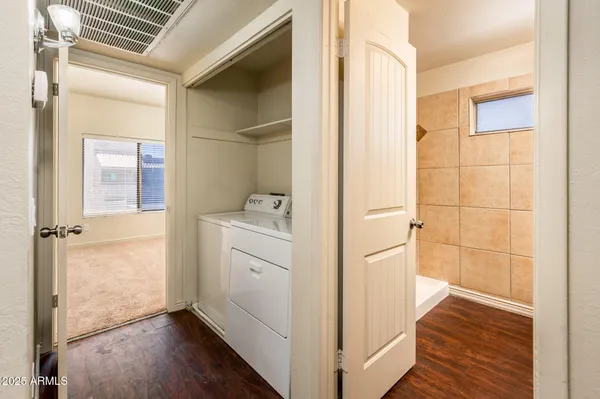 a room with a wooden floor and white doors