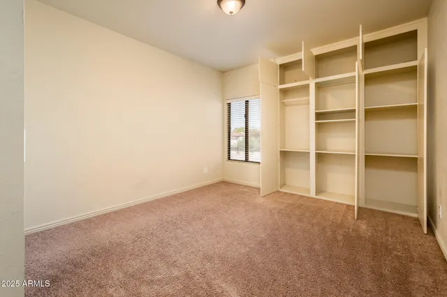 a view of an empty room with a closet
