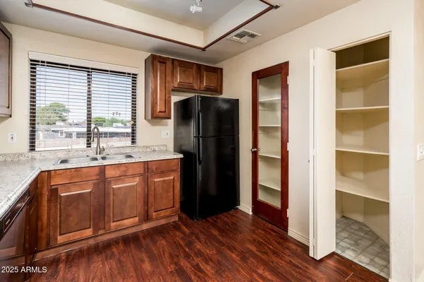 a kitchen with stainless steel appliances granite countertop a refrigerator and a sink