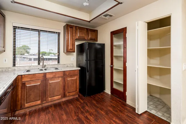 a kitchen with stainless steel appliances granite countertop a refrigerator and a sink
