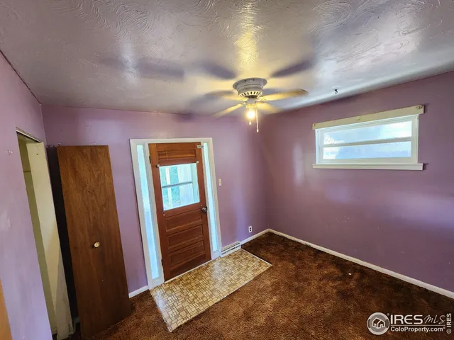 a view of room with window and wooden floor