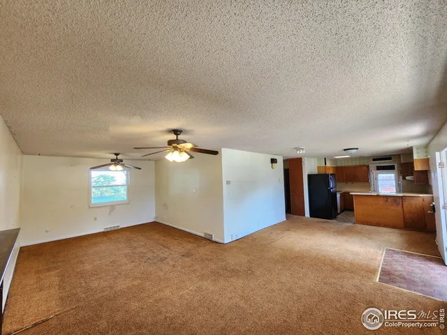 a view of a livingroom with furniture & cabinet