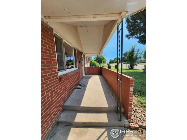 a view of a pathway of a house with a porch