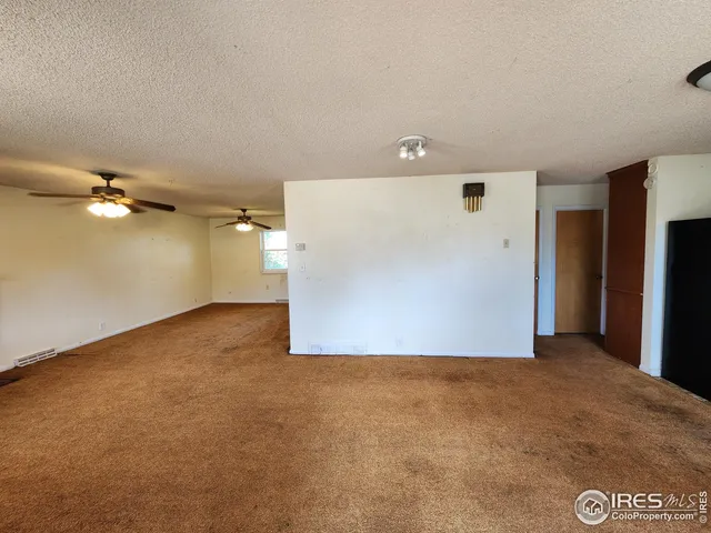 a view of a big room with a refrigerator
